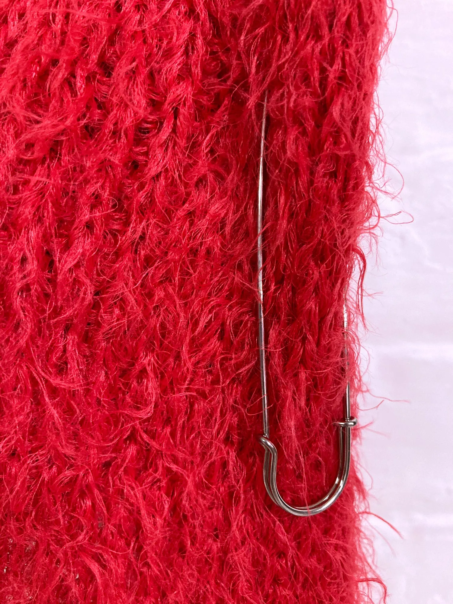 Jean Colonna red mohair-y scarf with safety pin